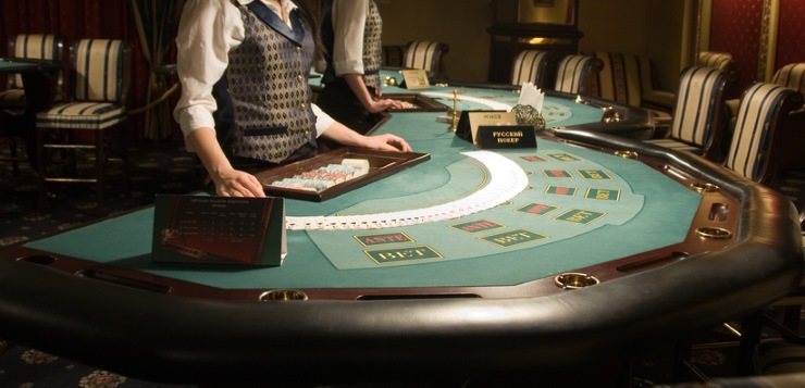 Dealer spreading cards on a blackjack table