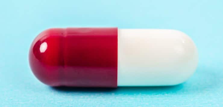 Red and white pharmaceutical pill